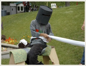 student pretending to joust on a pretend horse during the medieval fair